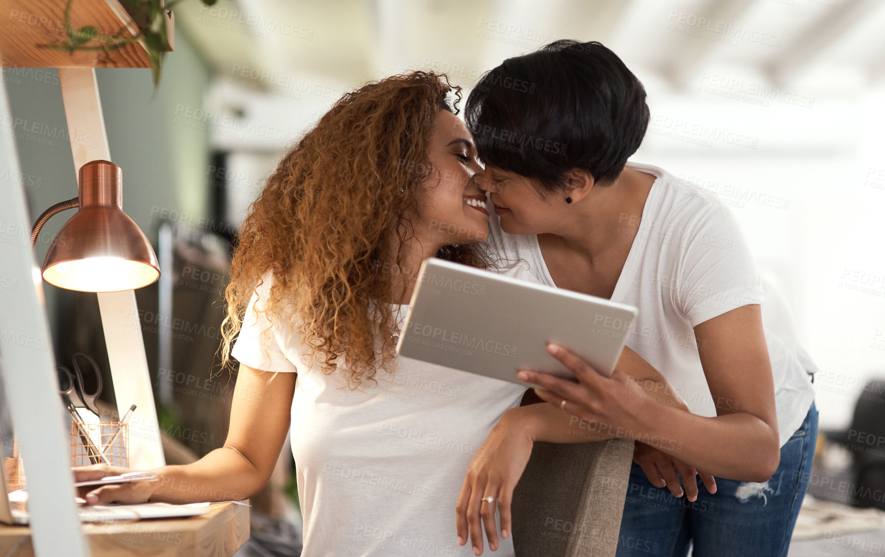 Buy stock photo Shot of a couple using a tablet in the lounge at home