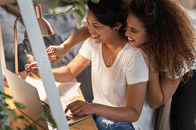 Buy stock photo Shot of a couple using a laptop in the lounge at home