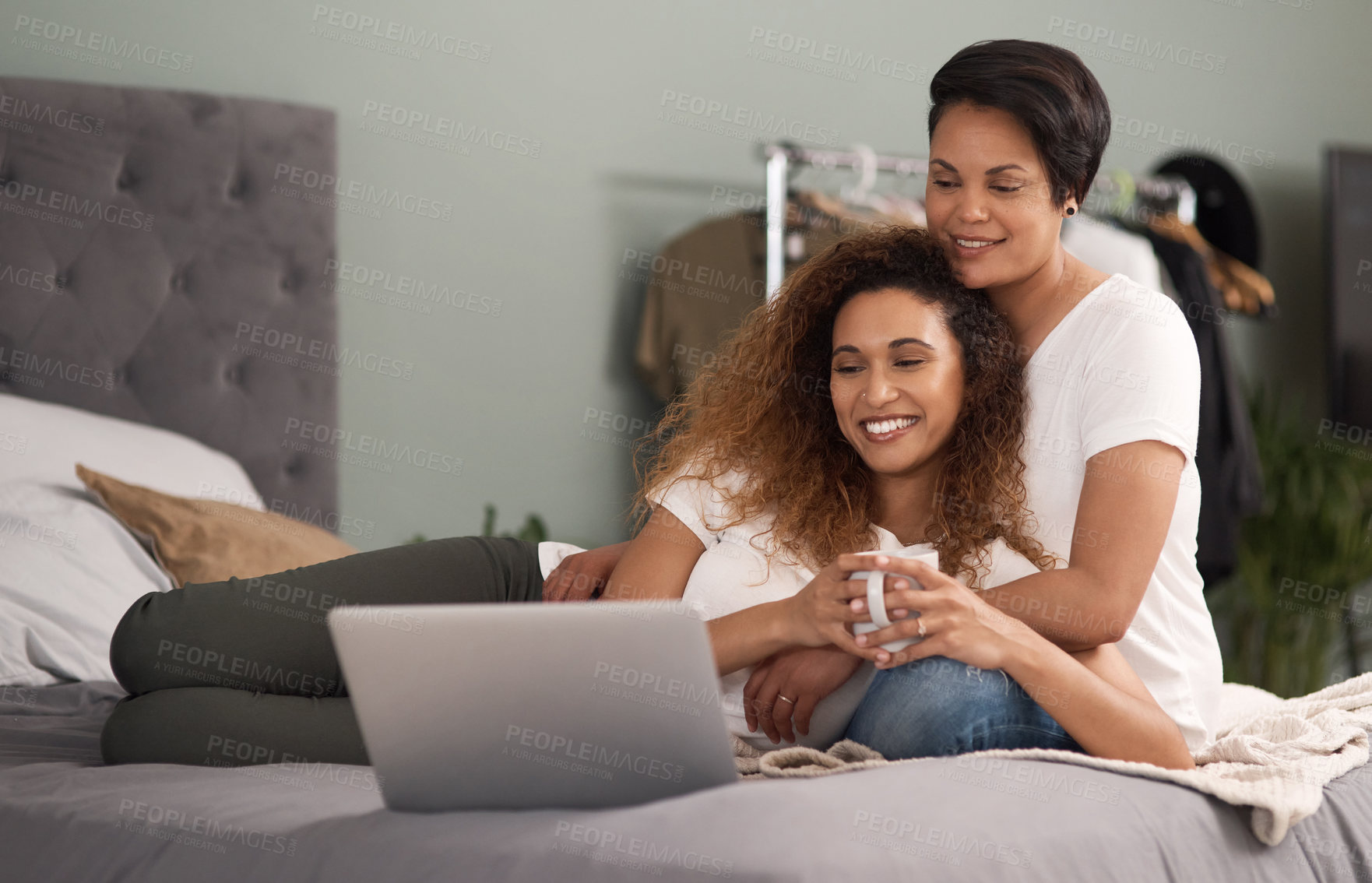 Buy stock photo Shot of a couple using a laptop while sitting on the bed at home