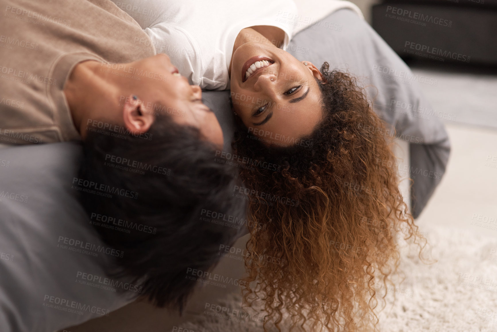 Buy stock photo Shot of a young lesbian couple relaxing in their bedroom at home