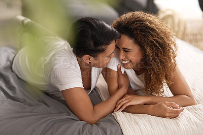 Buy stock photo Shot of a couple sharing a intimate moment in bed at home