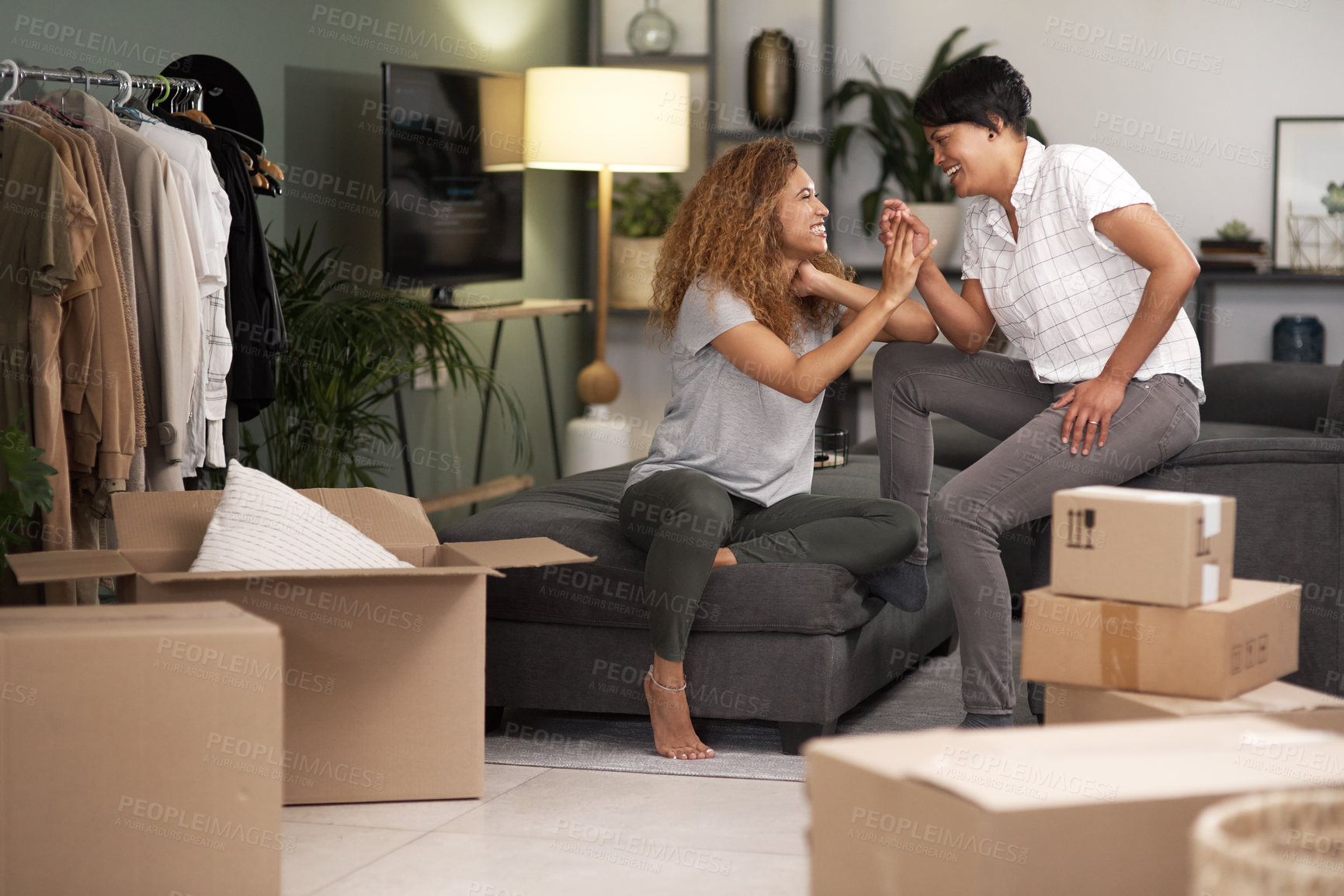 Buy stock photo Shot of a couple unpacking boxes in their new home