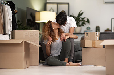 Buy stock photo Shot of a couple unpacking boxes in their new home