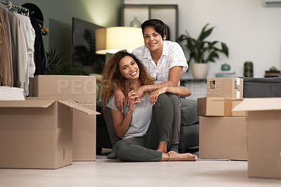 Buy stock photo Shot of a couple unpacking boxes in their new home