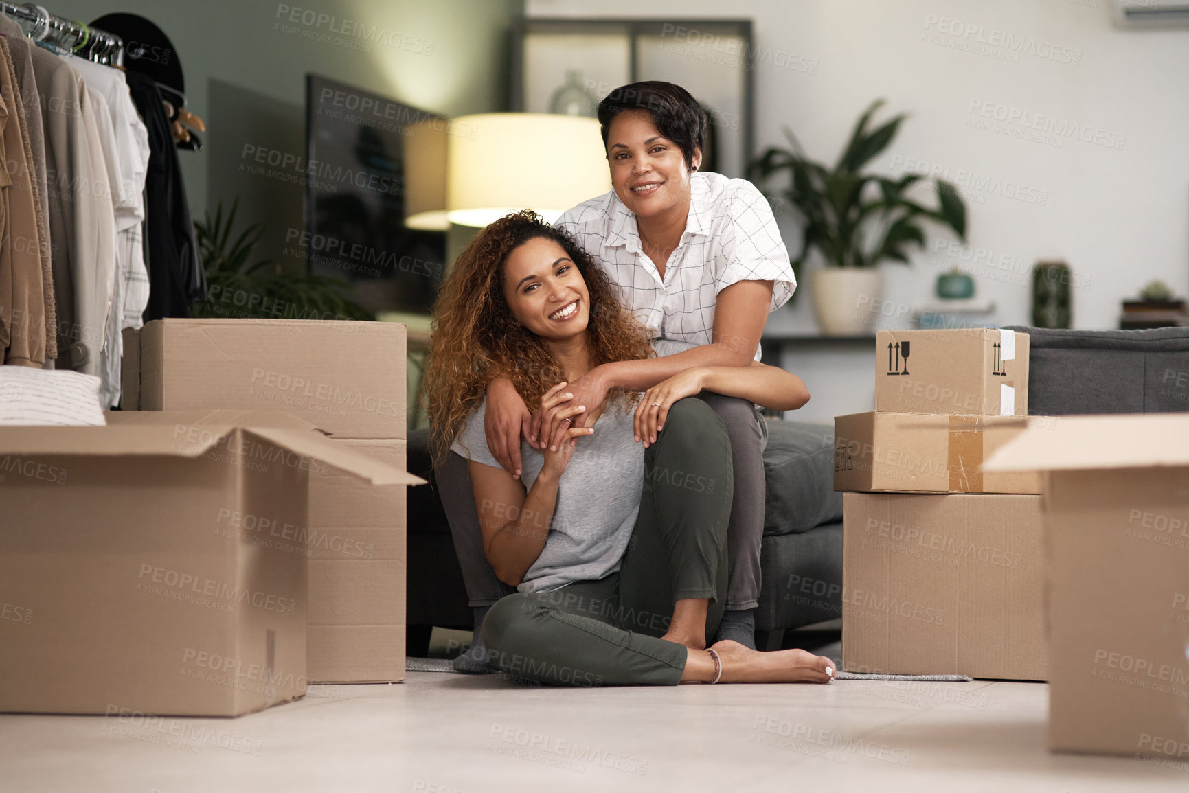 Buy stock photo Shot of a couple unpacking boxes in their new home