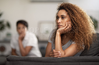 Buy stock photo Shot of a young woman ignoring her partner at home