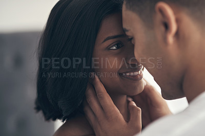 Buy stock photo Shot of a young couple sharing an intimate moment at home