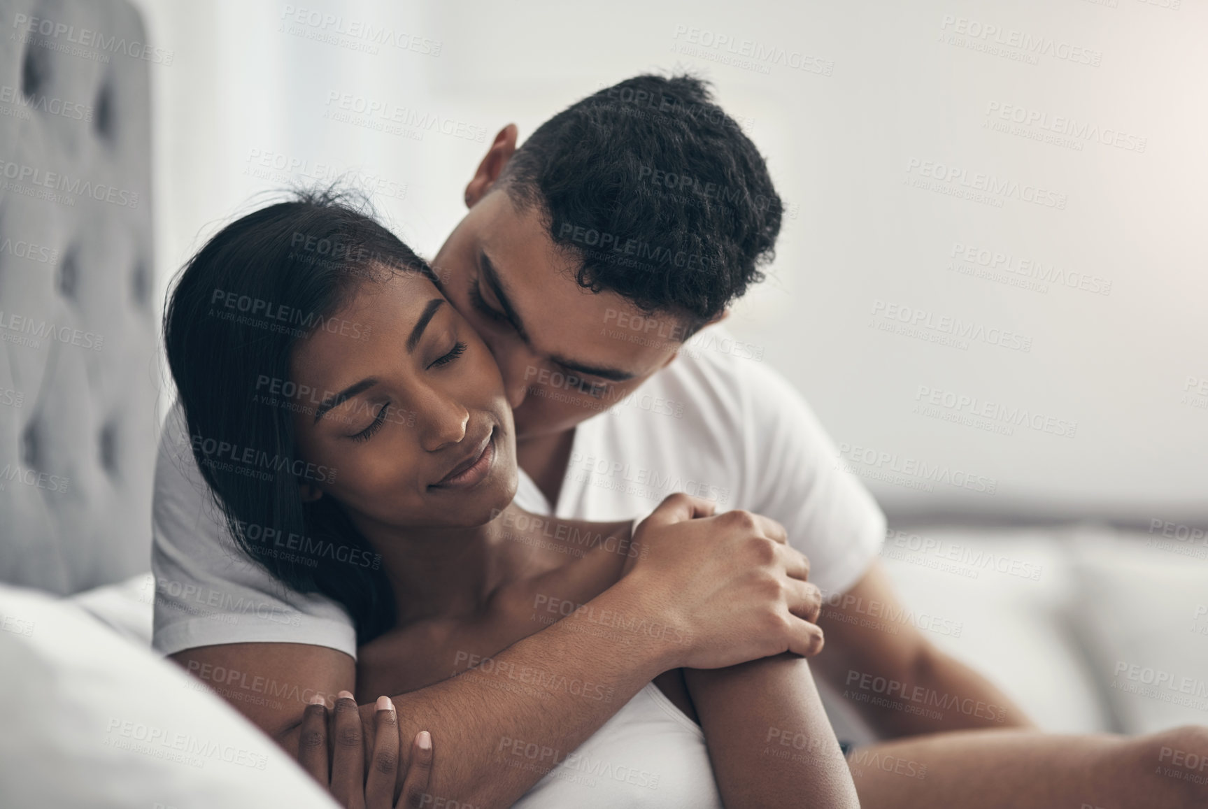 Buy stock photo Shot of a young couple sharing an intimate moment at home