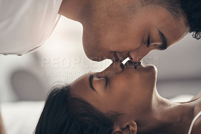 Buy stock photo Shot of a young couple sharing an intimate moment at home