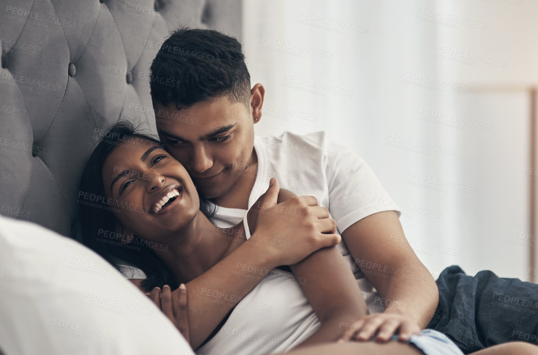 Buy stock photo Shot of a young couple sharing an intimate moment at home