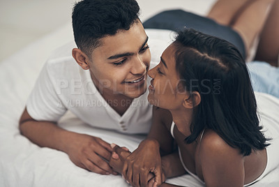 Buy stock photo Shot of a young couple sharing an intimate moment at home