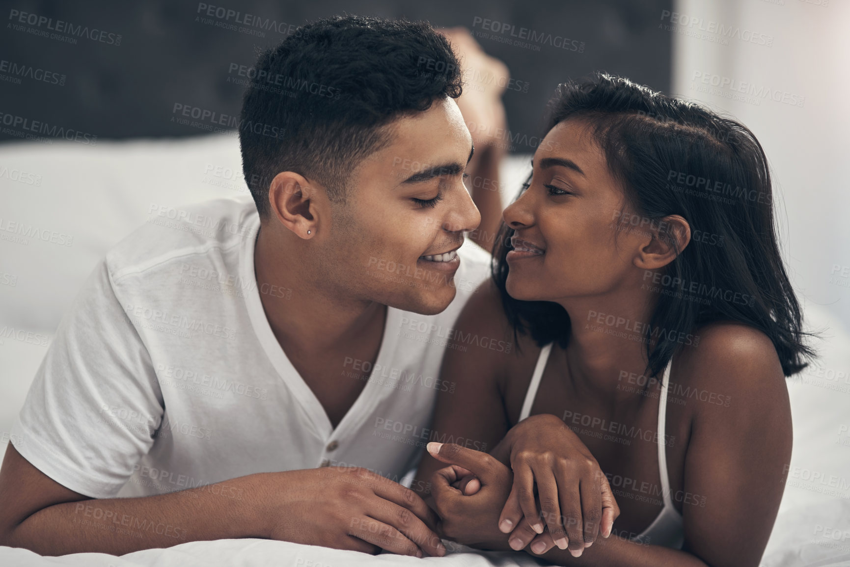 Buy stock photo Shot of a young couple sharing an intimate moment at home