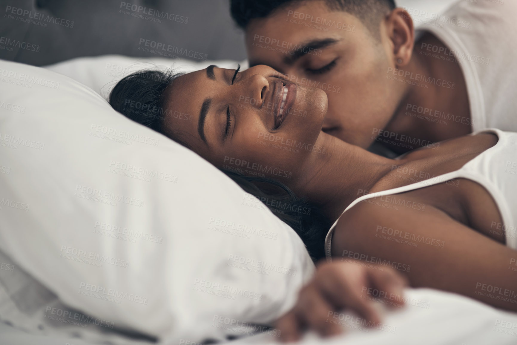 Buy stock photo Shot of a young couple sharing an intimate moment at home