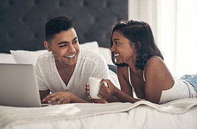 Buy stock photo Shot of a young couple using a laptop