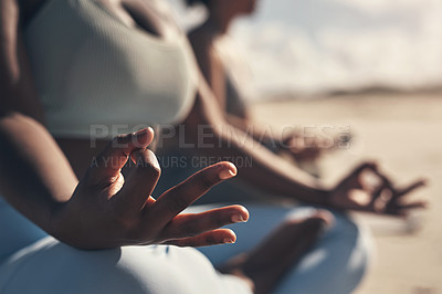 Buy stock photo Shot of a woman meditating during her yoga routine on the beach