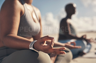 Buy stock photo Shot of a woman meditating during her yoga routine on the beach