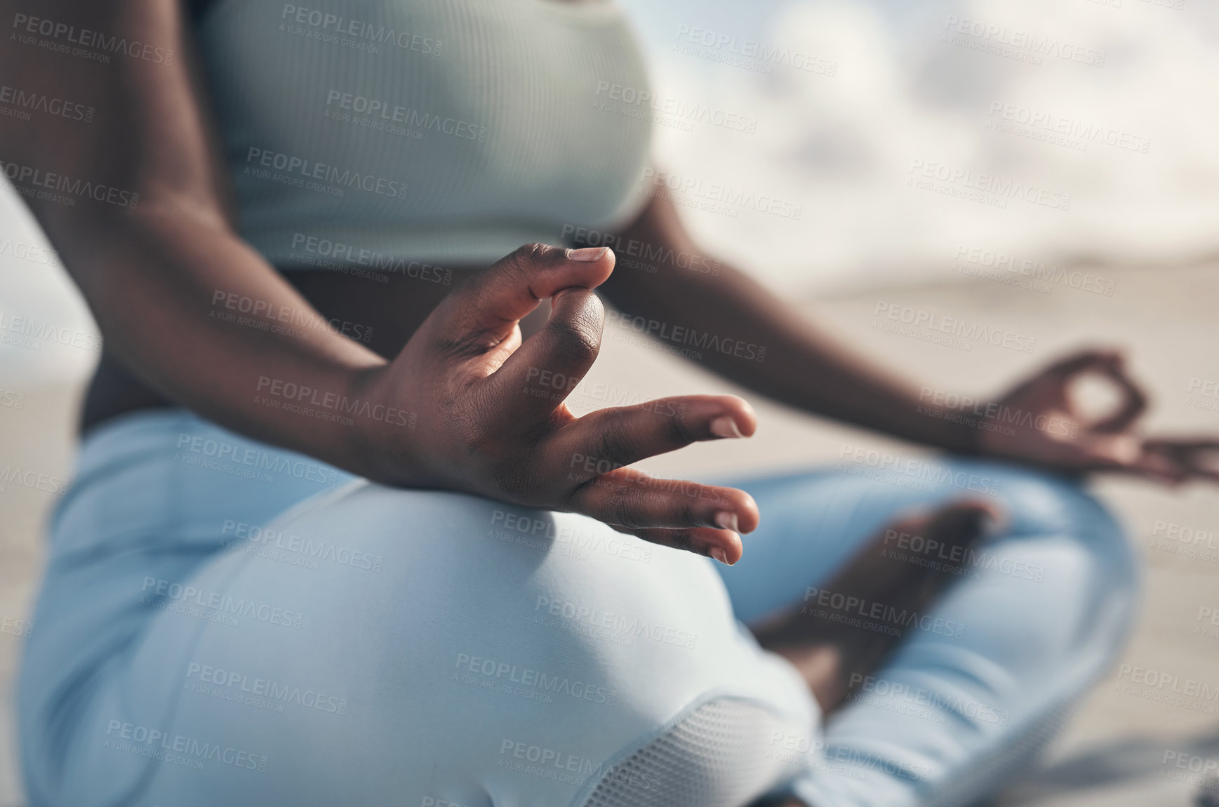 Buy stock photo Shot of a woman meditating during her yoga routine on the beach