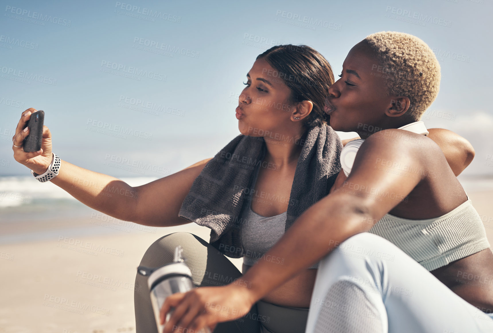 Buy stock photo Shot of two sporty young women taking a selfie while exercising at the beach