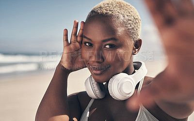Buy stock photo Shot of a sporty young woman posing with headphones around her neck