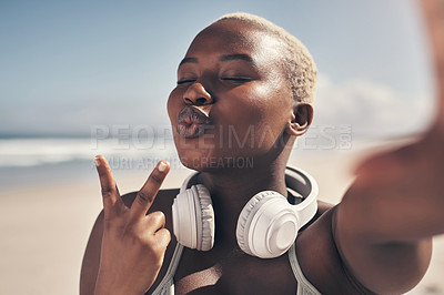 Buy stock photo Shot of a sporty young woman posing with headphones around her neck