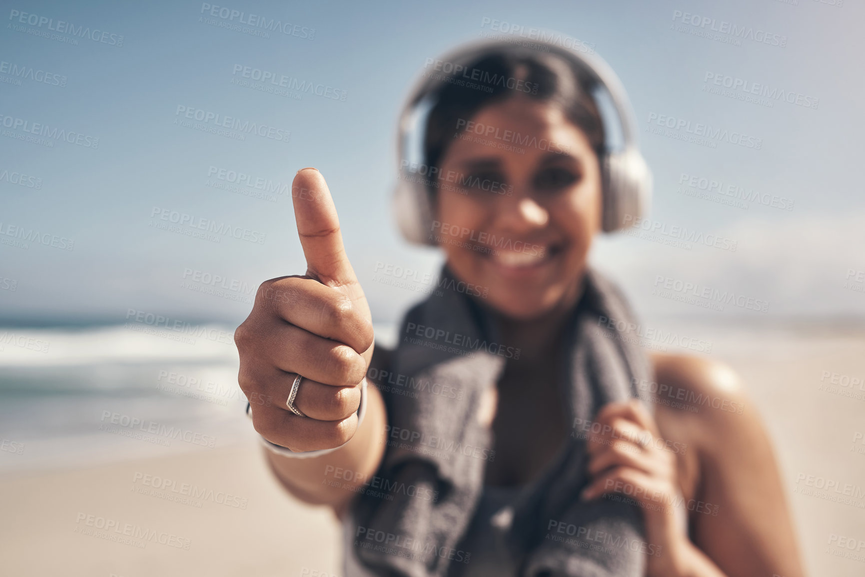 Buy stock photo Shot of a woman showing thumbs up while out for a workout