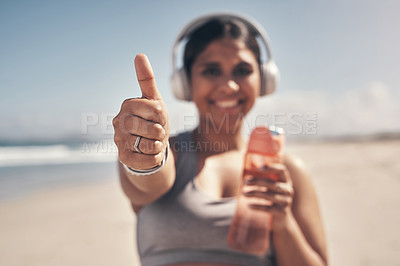 Buy stock photo Shot of a woman showing thumbs up while out for a workout