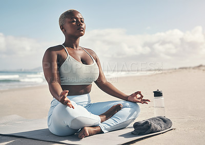 Buy stock photo Shot of a woman meditating during her yoga routine on the beach