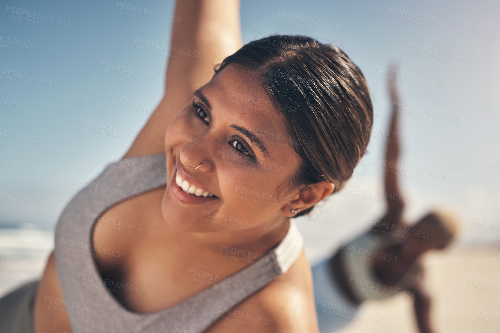 Buy stock photo Shot of a young woman exercising on the beach