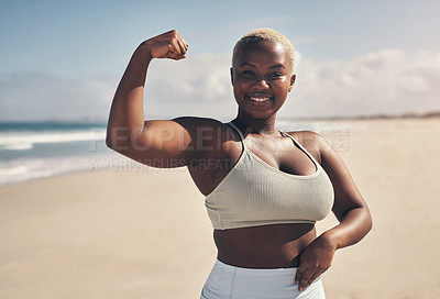 Buy stock photo Shot of a young woman flexing while out for a workout on the beach