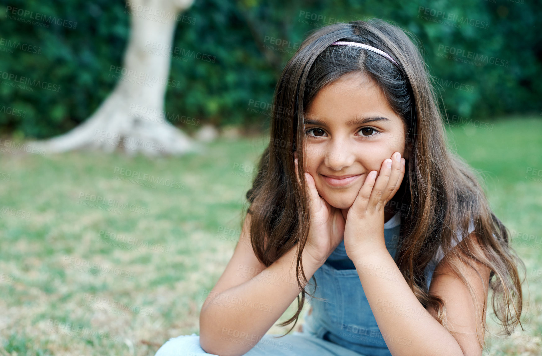 Buy stock photo Children, portrait and summer with girl on lawn to relax outdoor in fresh air for weekend time off. Face, nature and smile with happy young kid sitting on grass in park for development or growth