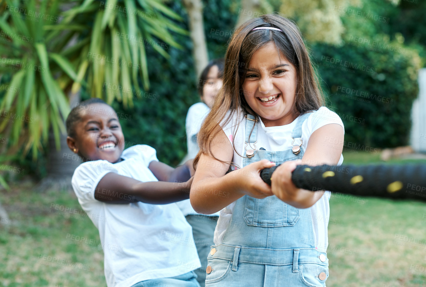 Buy stock photo Children, friends and rope tug for outdoor game or birthday party activity for winning, teamwork or garden. Girls, laughing and youth summer or weekend bonding for challenge, backyard or kindergarten