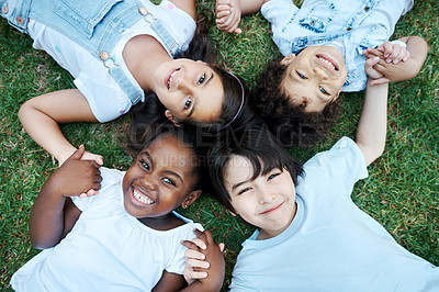 Buy stock photo Portrait, top view and kids on grass, holding hands and happiness with weekend break, outdoor and playful. Face, cheerful group and children on lawn, fun and bonding together in park, game or excited