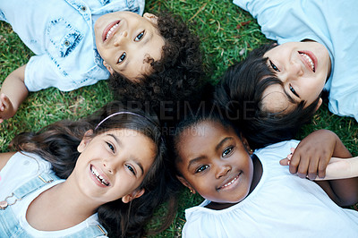 Buy stock photo Smile, circle and portrait of children in nature outdoor fun in park, field or garden together. Happy, diversity and top view of young kids relaxing and laying on lawn on grass or forest for summer