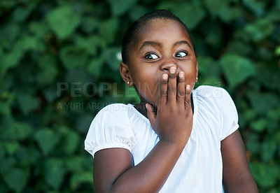 Buy stock photo Shot of an adorable little girl looking surprised while standing outside