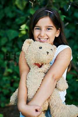 Buy stock photo Outdoor, portrait and girl with teddy bear, toys and hug with safety and security in home garden. Calm, kid and child relax with smile on face and embrace soft doll in backyard with happiness 