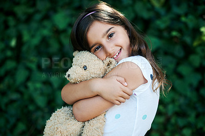 Buy stock photo Toys, portrait and girl hug teddy bear outdoor with safety and security in home and garden. Calm, kid or child relax with smile on face or embrace soft doll in backyard with happiness in kindergarten