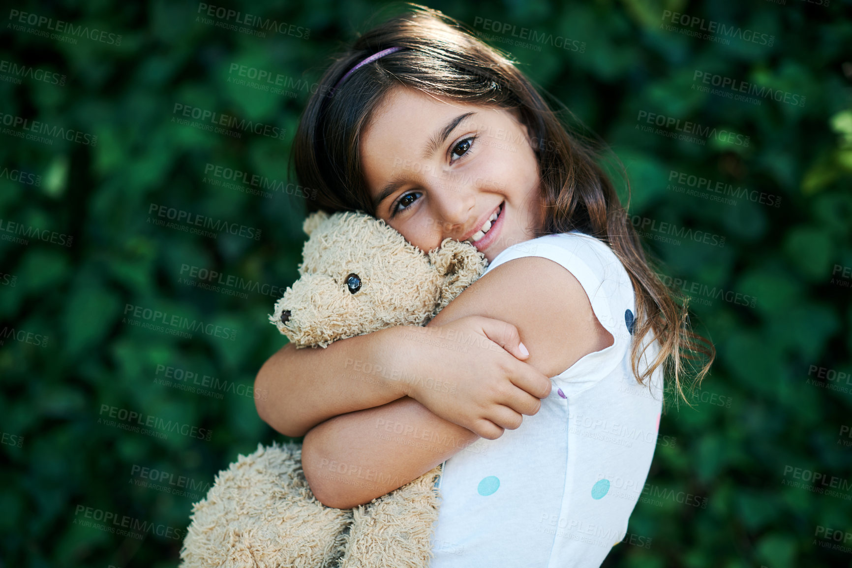 Buy stock photo Toys, portrait and girl hug teddy bear outdoor with safety and security in home and garden. Calm, kid or child relax with smile on face or embrace soft doll in backyard with happiness in kindergarten