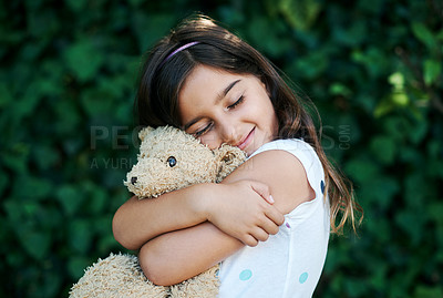 Buy stock photo Hug, toys and girl outdoor with teddy bear, safety and security in home and garden. Calm, kid or child relax with smile on face or embrace soft doll in backyard with happiness in kindergarten