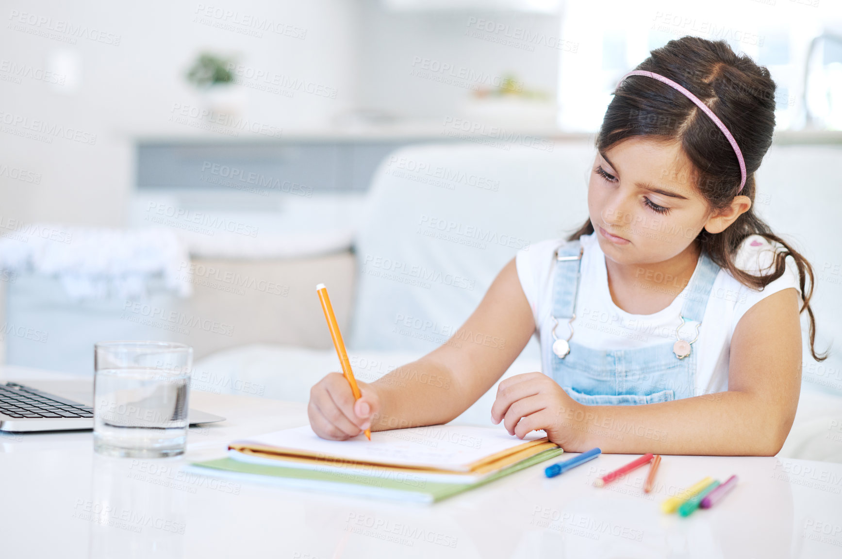 Buy stock photo Drawing, learning and kid by desk in home for child development, homework and knowledge. Creative, writing and young girl student with pencils for assignment, project or school test at house.