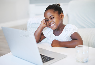 Buy stock photo Shot of a little girl using a laptop at home