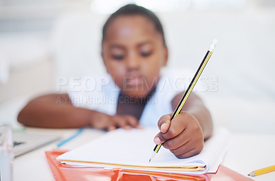 Buy stock photo Shot of a little girl writing in a book at home