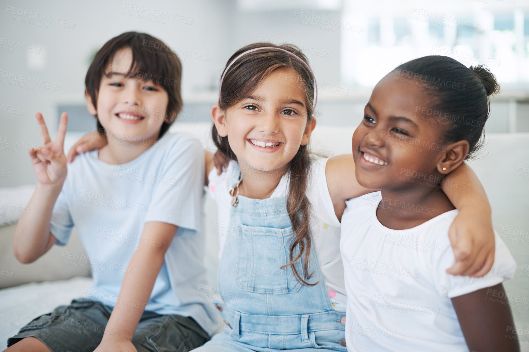 Buy stock photo Children, happy and relax on sofa with portrait for bonding with adopted sister on vacation, getaway and summer break. Black girl, siblings and peace sign in living room of holiday house and together