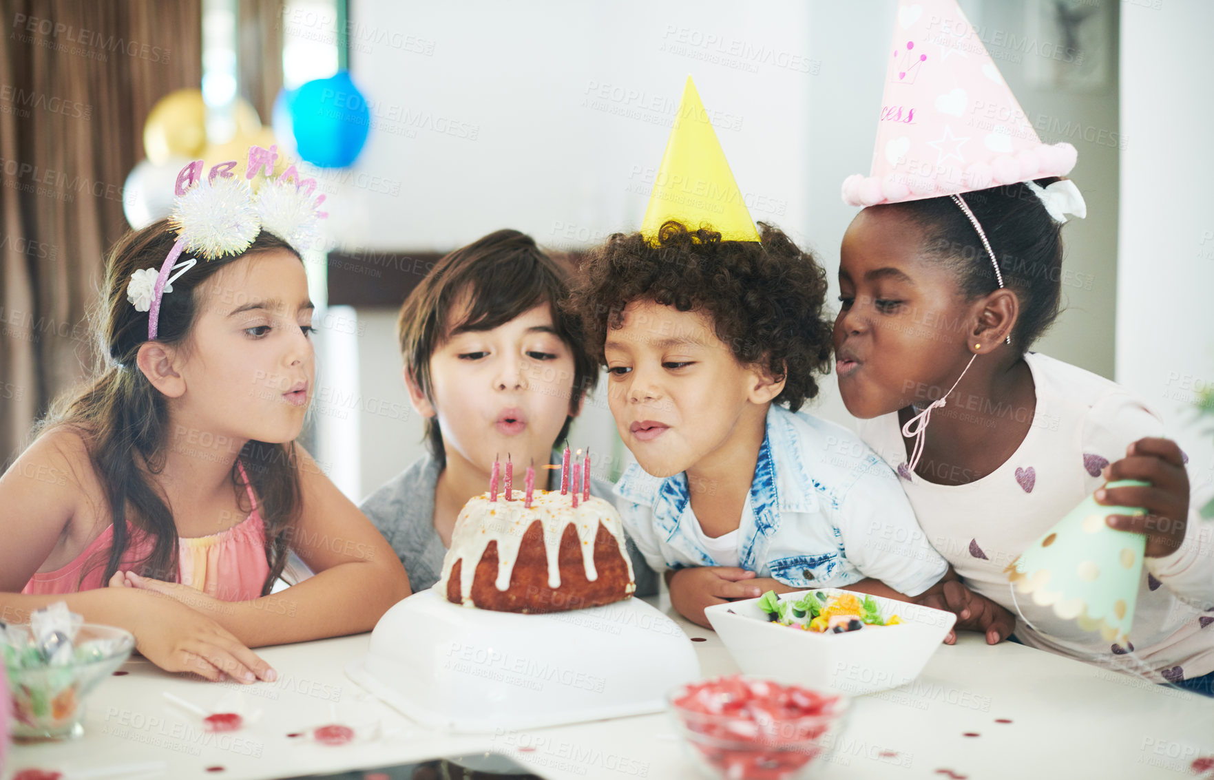 Buy stock photo Shot of four adorable kids celebrating together at a birthday party