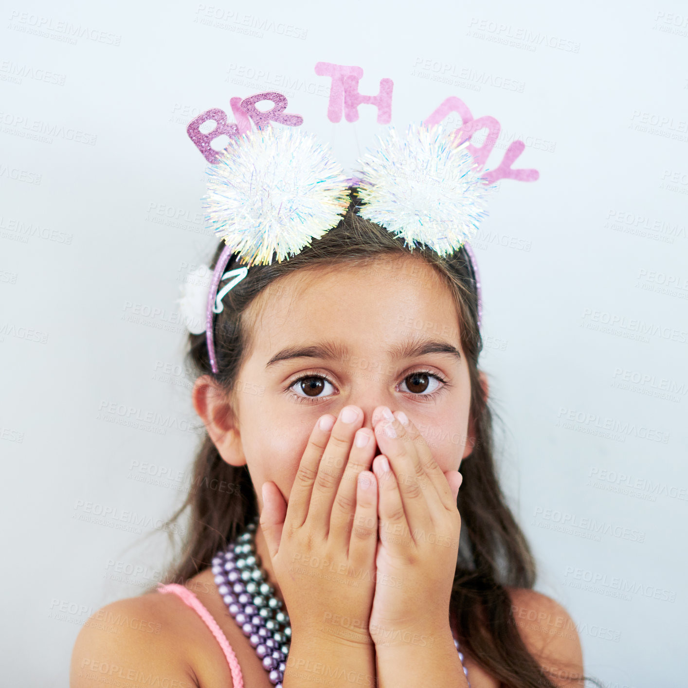 Buy stock photo Child, portrait and surprise hands at birthday party on white background in studio, excited or milestone. Girl, kid and face for celebration event or wow for youth omg with shock gesture or headband