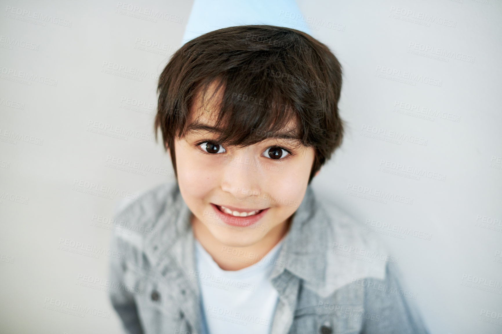 Buy stock photo Shot of an adorable little boy wearing a party hat