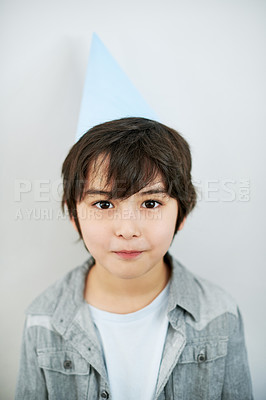 Buy stock photo Cute, party hat and portrait of Asian child in studio for birthday celebration or event. Happy, sweet and confident young boy kid with accessory for festive activity isolated by white background.