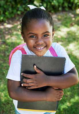 Buy stock photo Shot of a little girl wearing a backpack while carrying books in nature
