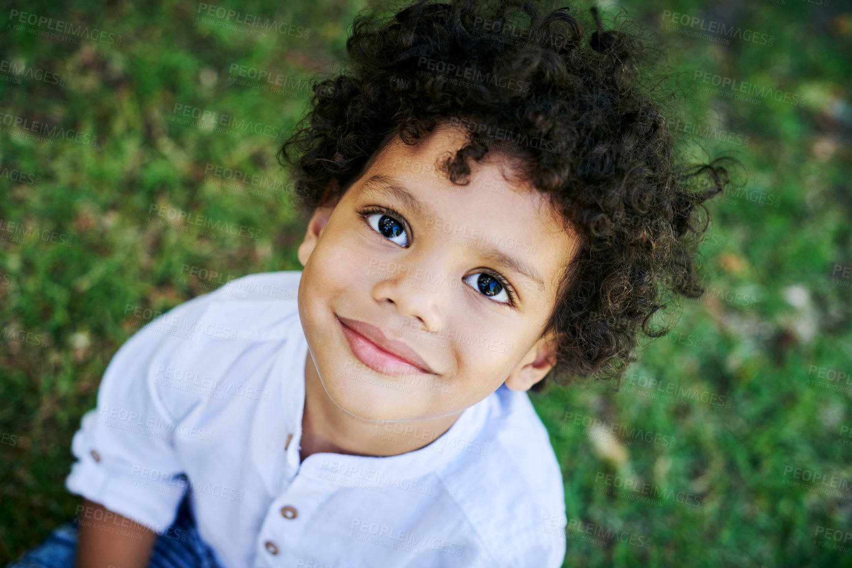 Buy stock photo Shot of a little boy smiling in nature