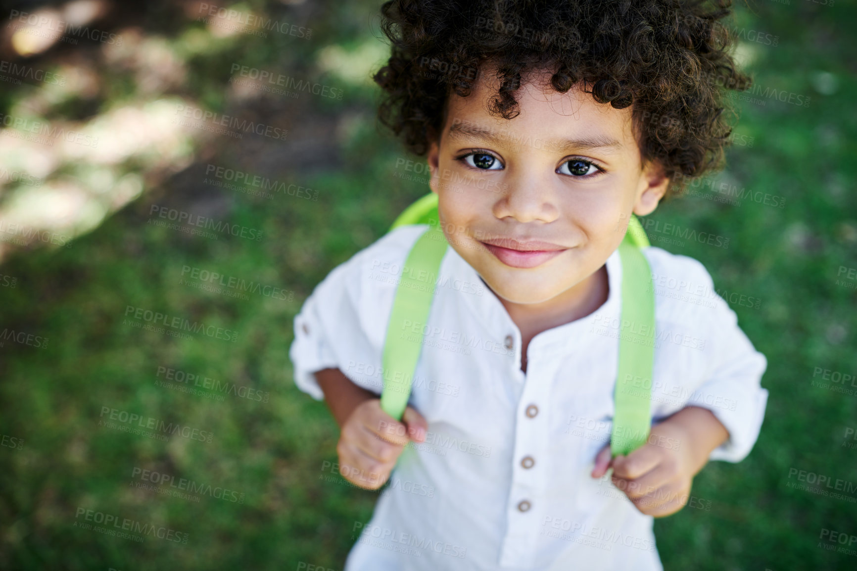 Buy stock photo Shot of a little boy wearing a backpack in nature