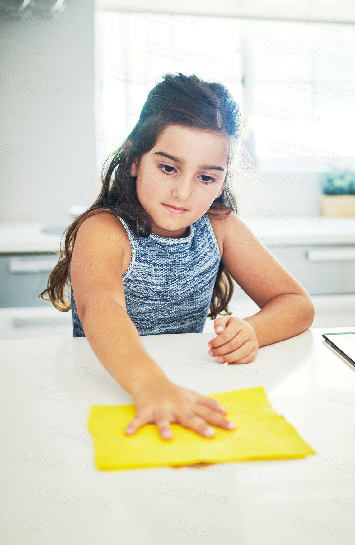 Buy stock photo Shot of an adorable little girl helping out with chores at home